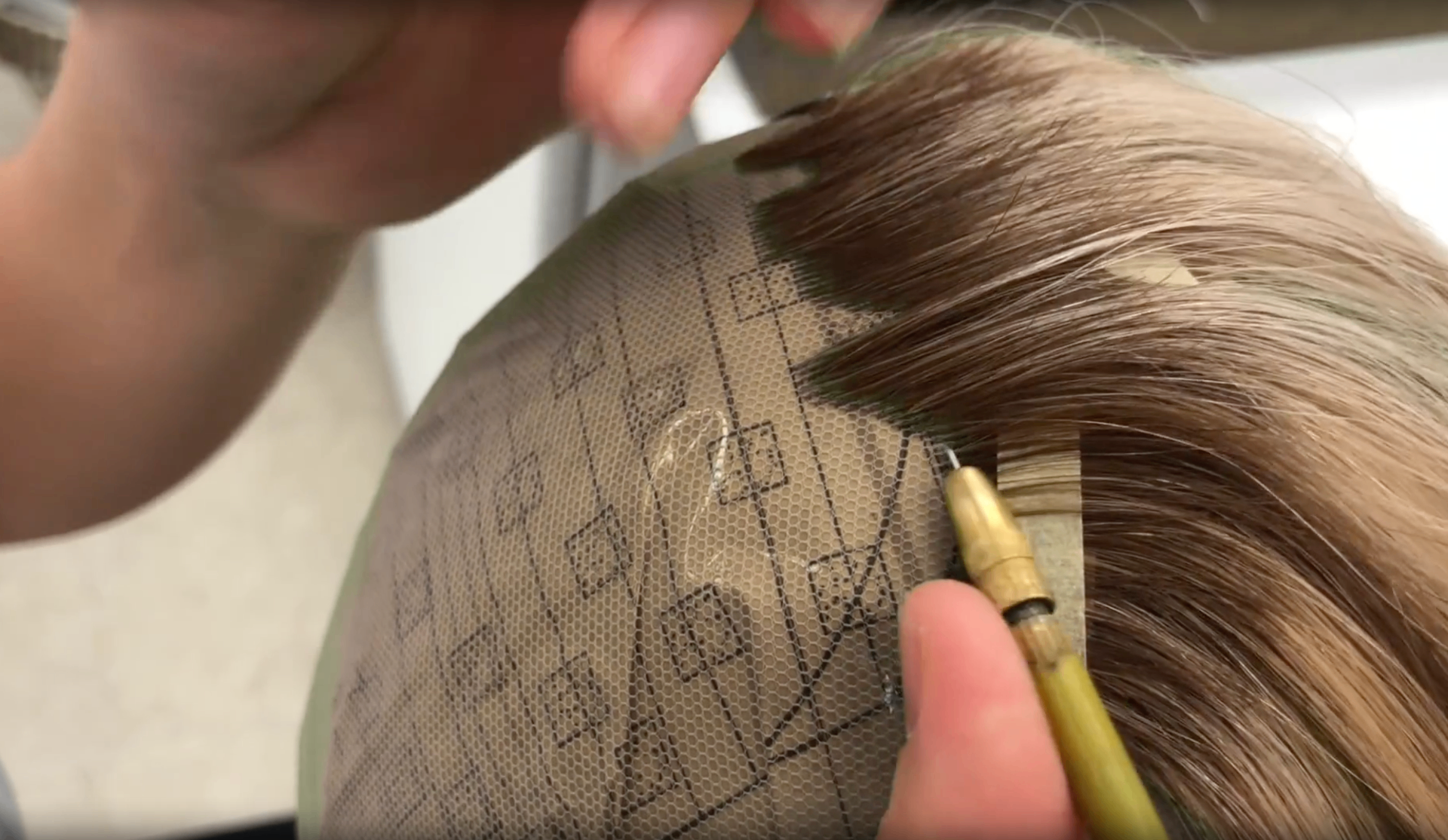 Hand-knotting detail of a Follea wig cap