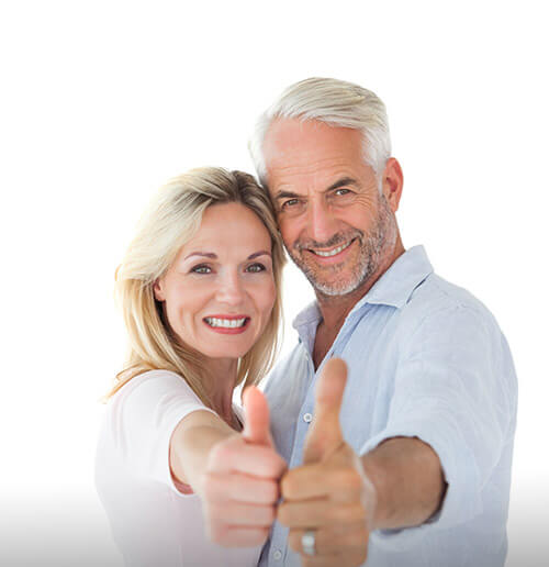 smiling couple in off white shirts sporting newly styled hair restoration
